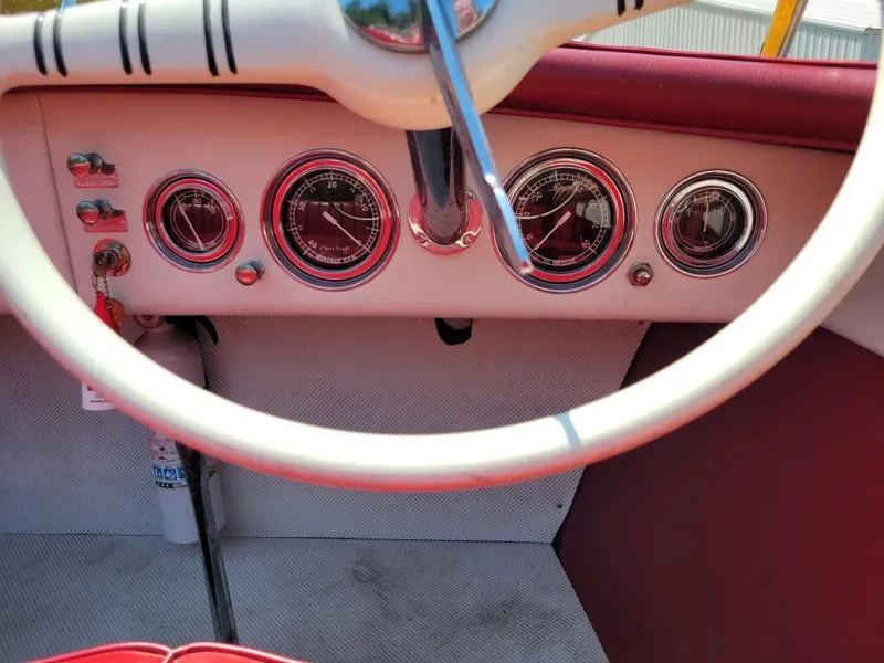 Slide: The Image of 1951 Chris-Craft Riviera 16 dashboard with vintage gauges and steering wheel. - 7