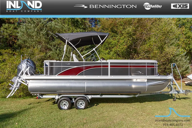 The Image of 2023 Bennington 22 SL pontoon boat on a trailer, displayed by Inland Boat Company. - 0