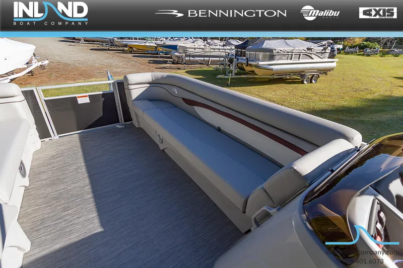 Slide: The Image of 2023 Bennington 22 SL pontoon boat interior with gray seating, displayed by Inland Boat Company. - 16
