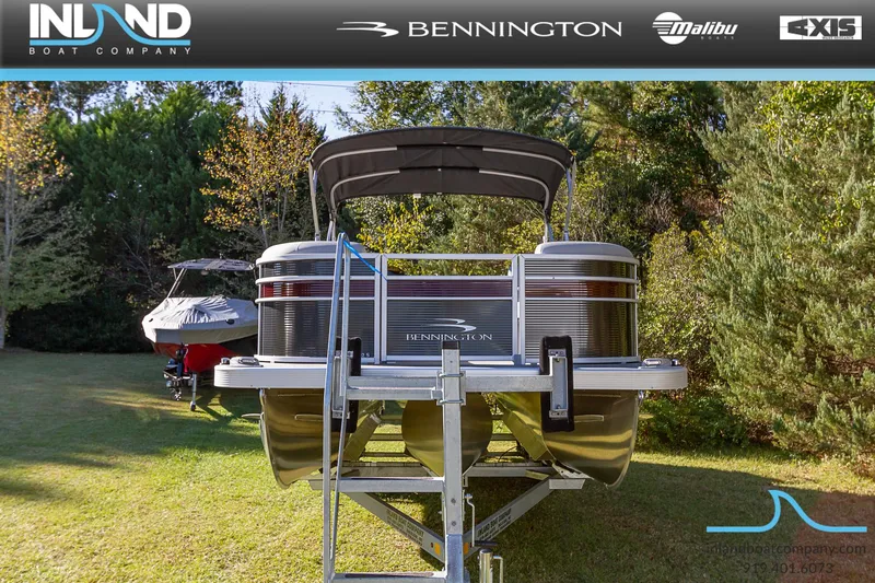 Slide: The Image of 2023 Bennington 22 SL pontoon boat on a trailer, displayed by Inland Boat Company. - 2