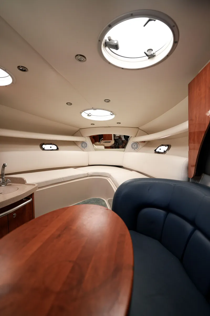 Slide: The Image of 2004 Four Winns Vista boat interior with seating and portholes. - 11