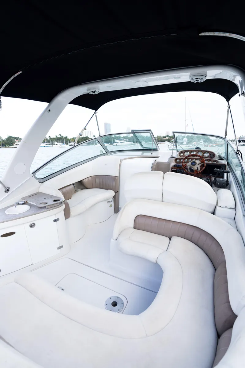 Slide: The Image of 2004 Four Winns Vista boat interior with white and beige seating. - 17