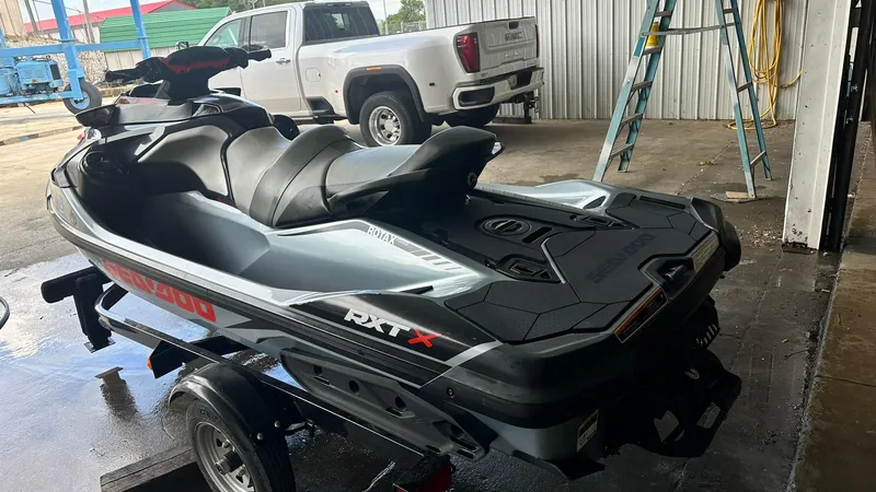 Slide: The Image of 2018 Sea-Doo RXT-X 300 jet ski on a trailer in a garage. - 1