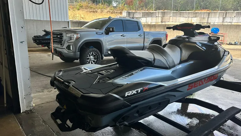 Slide: The Image of 2018 Sea-Doo RXT-X 300 jet ski in a garage with a pickup truck in the background. - 3