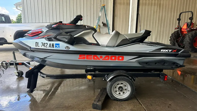 Slide: The Image of 2018 Sea-Doo RXT-X 300 jet ski on a trailer, parked in a garage. - 7