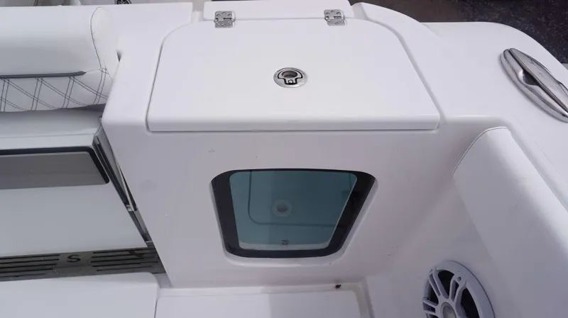 Slide: The Image of 2025 Sportsman 302 OPEN boat interior with storage compartment and cushioned seating. - 16