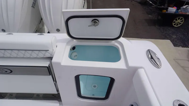 Slide: The Image of 2025 Sportsman 302 OPEN boat with open storage compartment and cushioned seating. - 17