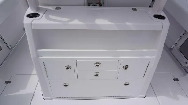 Slide: The Image of 2025 Sportsman 302 OPEN boat storage compartments and cup holders. - 18