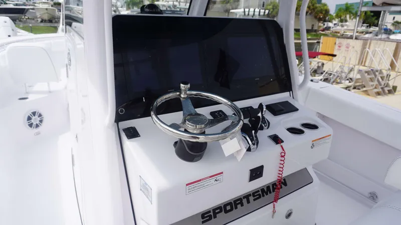 Slide: The Image of Control console of the 2025 Sportsman 302 OPEN boat with steering wheel and navigation screens. - 20