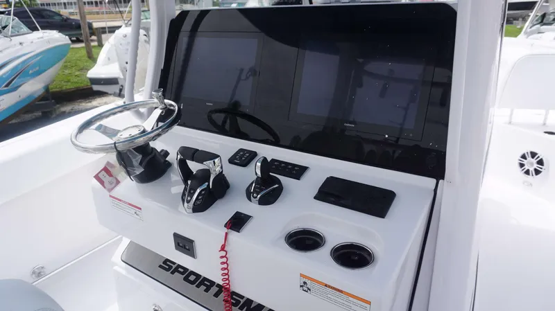 Slide: The Image of Control console of the 2025 Sportsman 302 OPEN boat with steering wheel and navigation screens. - 21