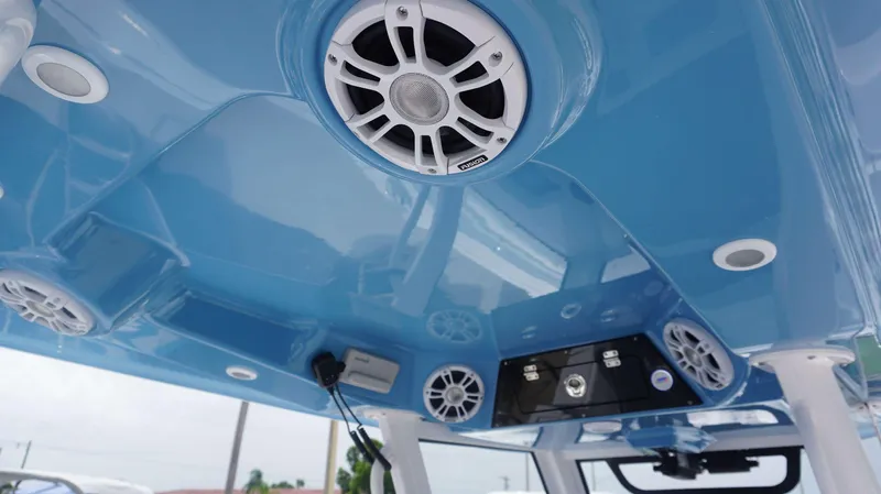 Slide: The Image of 2025 Sportsman 302 OPEN boat interior with blue ceiling and audio system. - 22