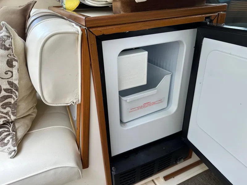 Slide: The Image of Open mini fridge inside a 1986 Sea Ray 390 Express Cruiser boat. - 10