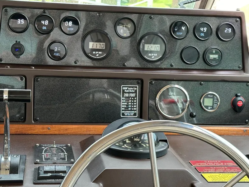 Slide: The Image of Dashboard of a 1986 Sea Ray 390 Express Cruiser with gauges and controls. - 12