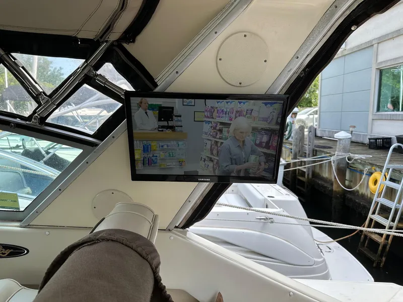 Slide: The Image of Flat-screen TV inside 1986 Sea Ray 390 Express Cruiser, docked at marina. - 14