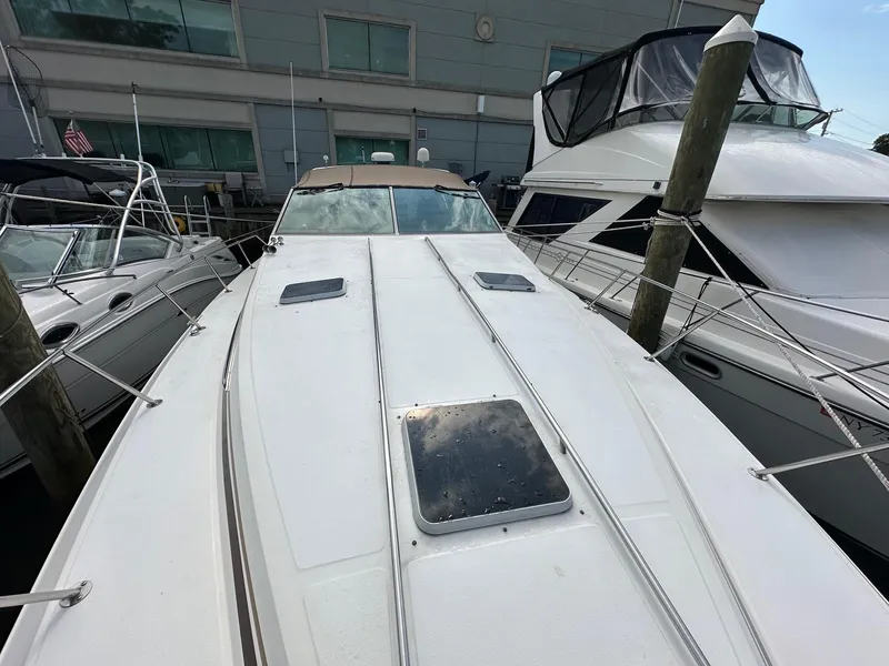 Slide: The Image of 1986 Sea Ray 390 Express Cruiser docked at a marina. - 2