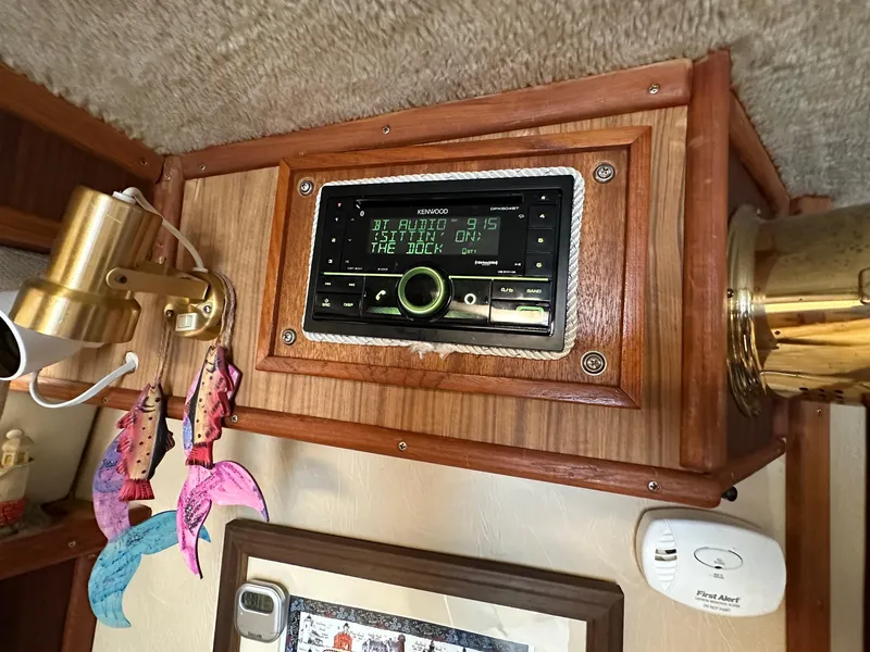 Slide: The Image of 1986 Sea Ray 390 Express Cruiser cabin with Kenwood stereo system and nautical decor. - 21