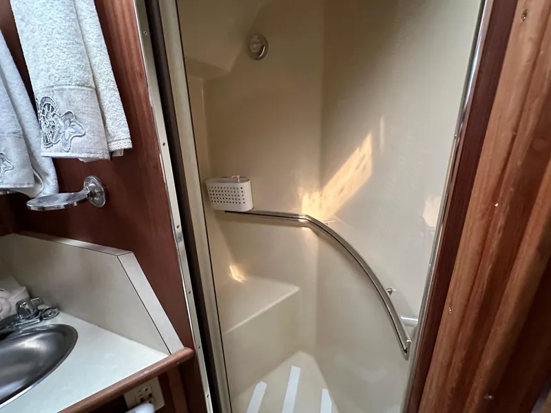 Slide: The Image of 1986 Sea Ray 390 Express Cruiser bathroom with shower and sink. - 23