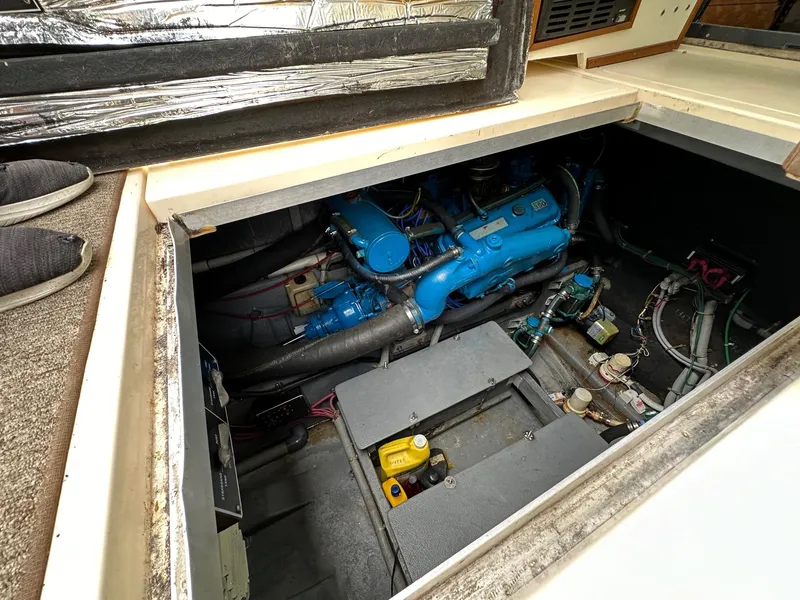 Slide: The Image of Engine compartment of a 1986 Sea Ray 390 Express Cruiser with visible blue engine. - 27
