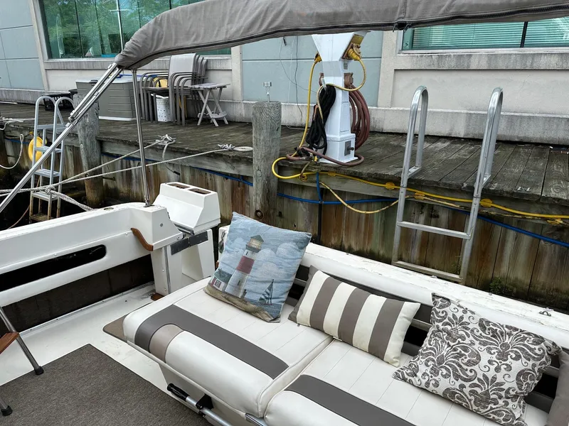 Slide: The Image of 1986 Sea Ray 390 Express Cruiser interior with striped cushions and nautical-themed decor. - 6