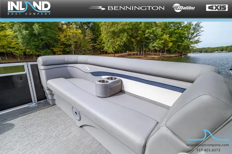 Slide: The Image of 2023 Bennington 20 SLM pontoon boat with gray seating, cup holder, and lake view. - 15