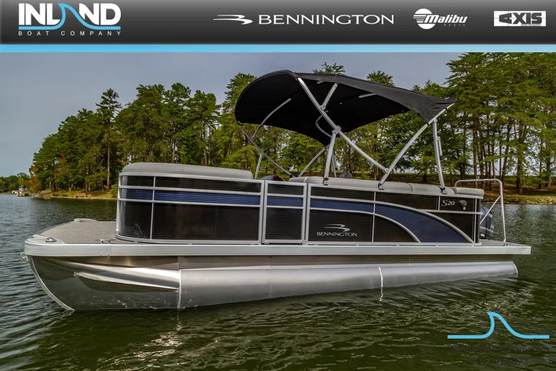 Slide: The Image of 2023 Bennington 20 SLM pontoon boat on a lake with a canopy. - 2