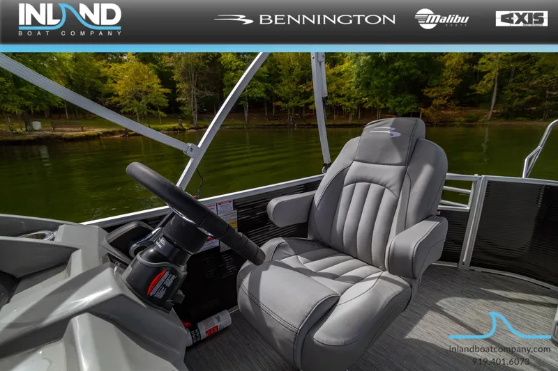Slide: The Image of 2023 Bennington 20 SLM boat interior with captain's chair and steering wheel. - 20
