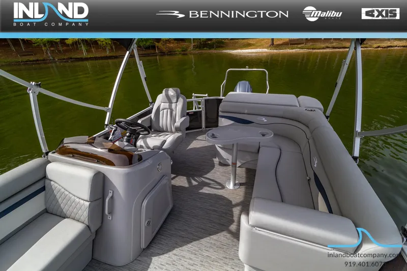 Slide: The Image of 2023 Bennington 20 SLM pontoon boat interior with plush seating and steering console. - 22