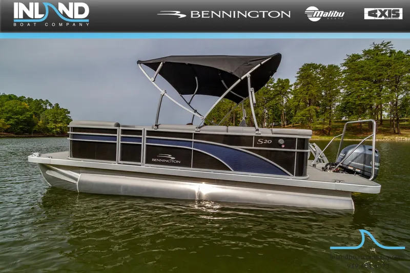 Slide: The Image of 2023 Bennington 20 SLM pontoon boat on a lake with a black canopy. - 3