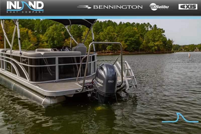 Slide: The Image of 2023 Bennington 20 SLM pontoon boat on a lake with Yamaha outboard motor. - 4