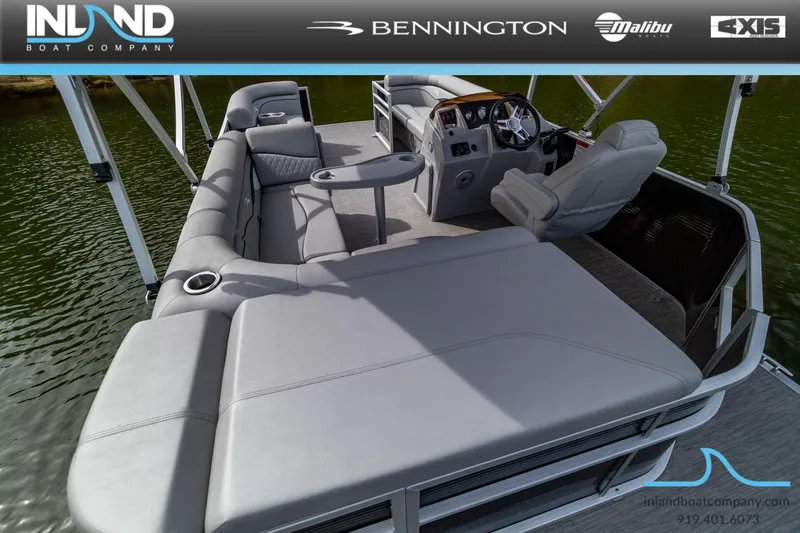 Slide: The Image of 2023 Bennington 20 SLM pontoon boat interior with plush seating and helm. - 5