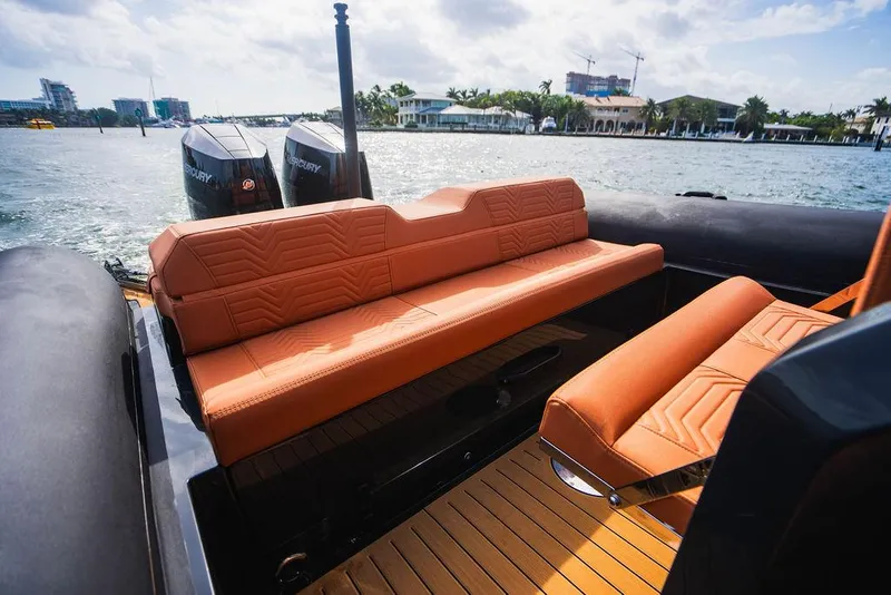 Slide: The Image of 2024 Onda Magna boat with orange leather seats and twin Mercury outboard engines. - 7