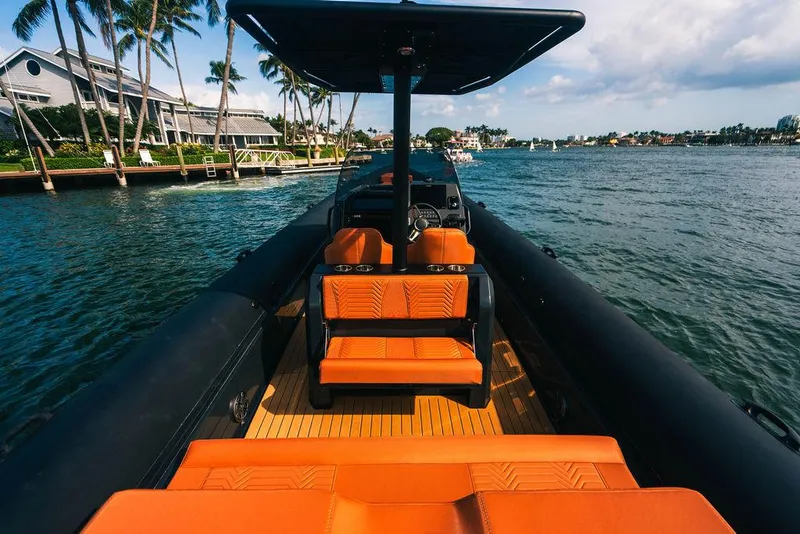 Slide: The Image of 2024 Onda Magna boat with orange seats cruising on a scenic waterway. - 16