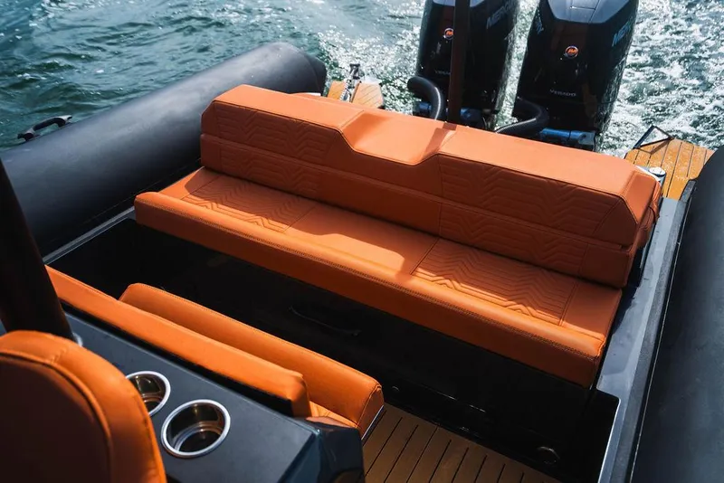 Slide: The Image of 2024 Onda Magna boat with orange seating and dual outboard motors. - 17