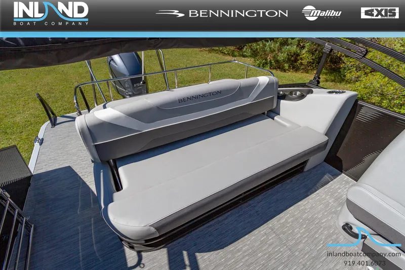 Slide: The Image of 2023 Bennington 22 SXSB boat interior with gray seating, displayed by Inland Boat Company. - 18