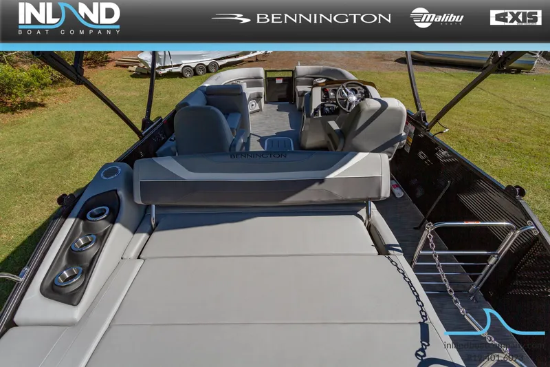 Slide: The Image of 2023 Bennington 22 SXSB pontoon boat interior with plush seating and modern dashboard. - 23