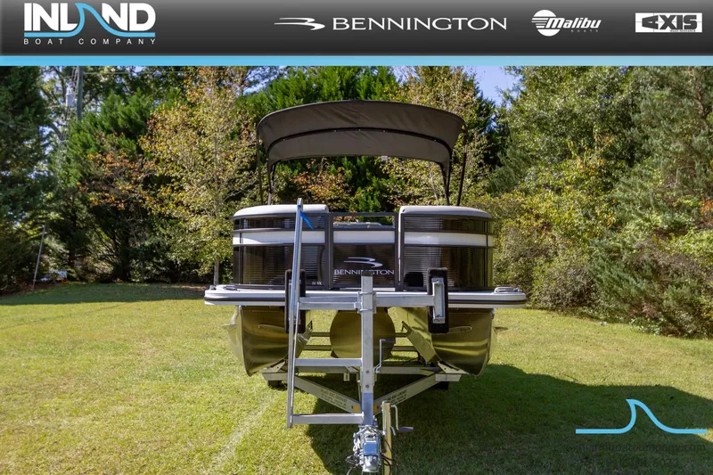 Slide: The Image of 2023 Bennington 22 SXSB pontoon boat on a trailer in a grassy area. - 4