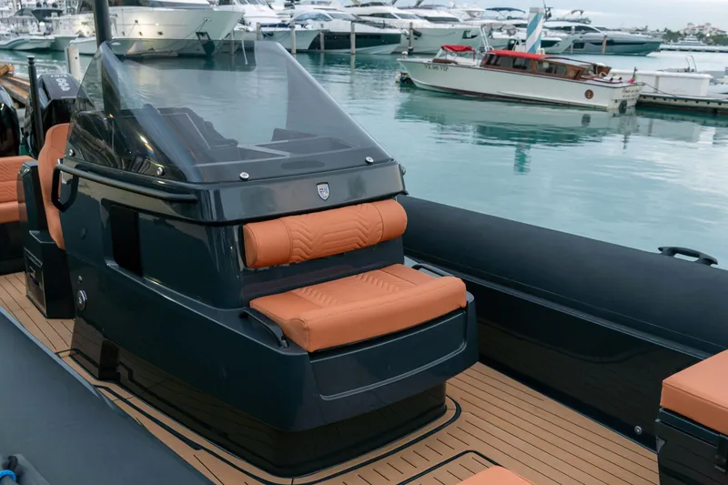 Slide: The Image of 2024 Onda Magna luxury boat with sleek design and leather seating at a marina. - 2