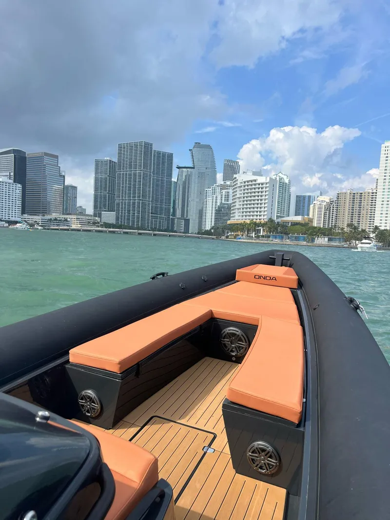 Slide: The Image of 2024 Onda Magna boat cruising near city skyline with modern buildings. - 4