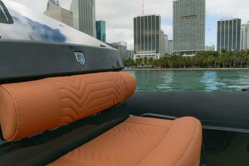 Slide: The Image of 2024 Onda Magna boat with tan leather seats, city skyline in background. - 5