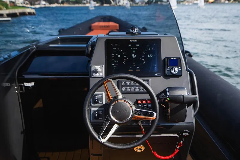 Slide: The Image of 2024 Onda Magna boat dashboard with steering wheel and navigation display on water. - 17