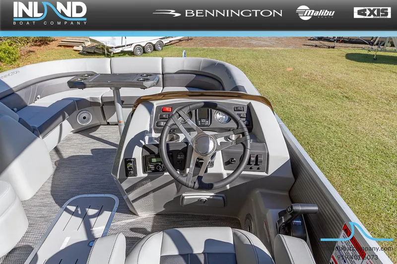 Slide: The Image of 2023 Bennington 22 SXSR boat interior with steering wheel and seating, displayed by Inland Boat Company. - 10