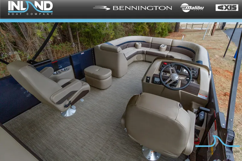 Slide: The Image of 2023 Bennington 22 SXSB pontoon boat interior with beige seating and steering console. - 13