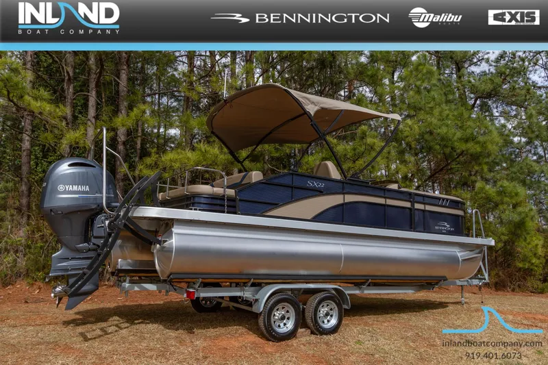Slide: The Image of 2023 Bennington 22 SXSB pontoon boat on a trailer with Yamaha outboard motor. - 2