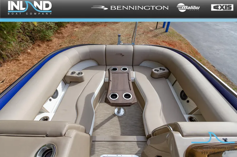 Slide: The Image of 2023 Bennington 23 LTSB boat interior with beige seating and cup holders. - 14