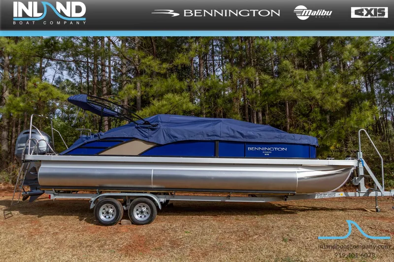 Slide: The Image of 2023 Bennington 23 LTSB pontoon boat on a trailer, covered with a blue canopy. - 29