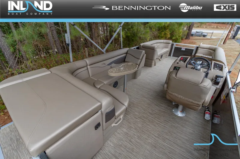 Slide: The Image of 2023 Bennington 22 SL pontoon boat interior with beige seating and helm. - 10