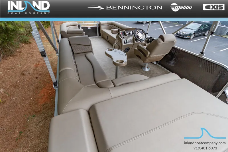Slide: The Image of 2023 Bennington 22 SL pontoon boat interior with beige seating and modern helm. - 11