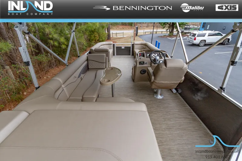 Slide: The Image of 2023 Bennington 22 SL pontoon boat interior with beige seating and steering console. - 12