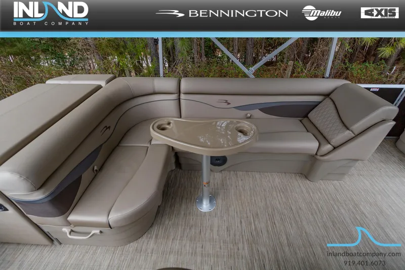 Slide: The Image of 2023 Bennington 22 SL pontoon boat with luxurious seating and table. - 14