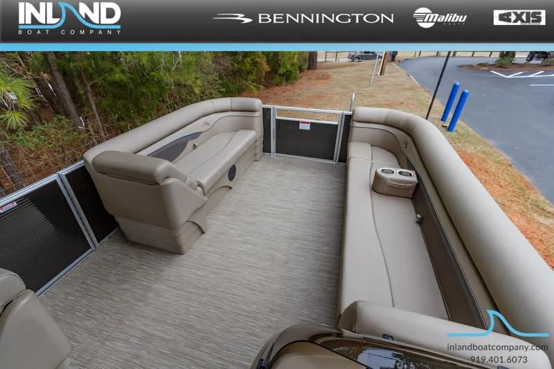 Slide: The Image of 2023 Bennington 22 SL pontoon boat interior with beige seating and cup holders. - 19